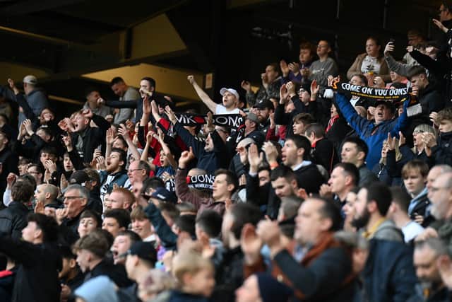 MK Dons supporters celebrate the 1-0 win over Morecambe on Saturday
