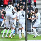 MK Dons take on Cheltenham Town on Saturday looking to make it four home games unbeaten