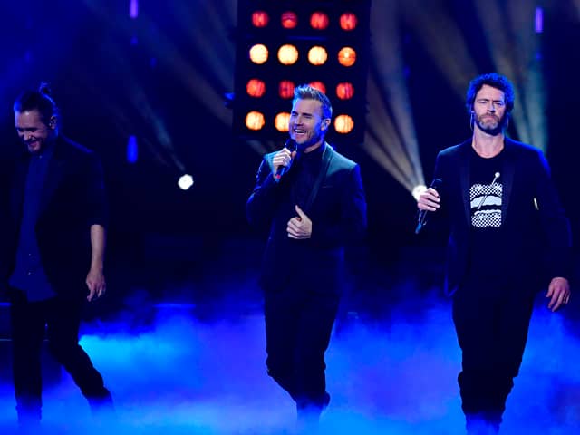 Take That bandmates Mark Owen, Gary Barlow and Howard Donald