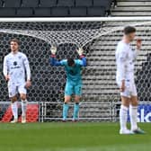 MK Dons look dejected and deflated after conceding a 97th minute equaliser against Cheltenham Town