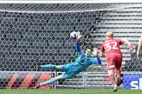 Jamie Cumming did brilliantly to save Alfie May’s second-half penalty