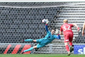 Jamie Cumming did brilliantly to save Alfie May’s second-half penalty