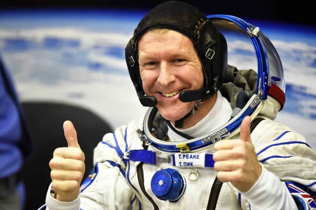 Britain's astronaut Tim Peake gestures as his space suit is tested at the Russian-leased Baikonur cosmodrome (photo: Getty Images)