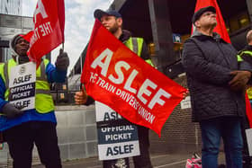 ASLEF (Associated Society of Locomotive Engineers and Firemen) members hold union flags at the picket outside Euston Station as train drivers continue their strike across the UK. (Photo by Vuk Valcic/SOPA Images/LightRocket via Getty Images)