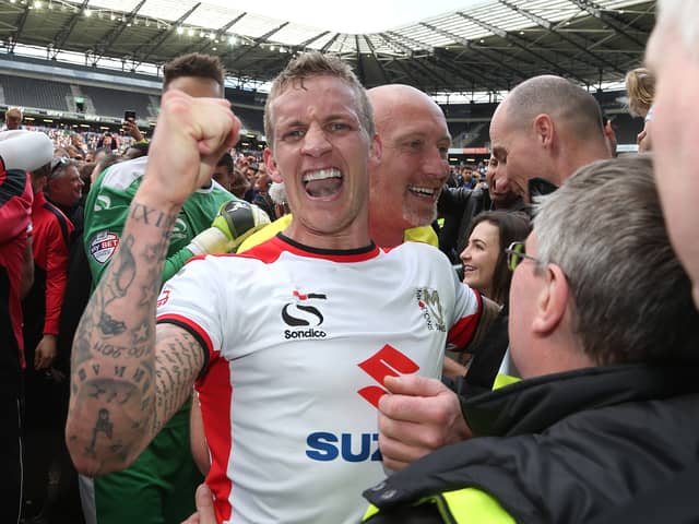 Carl Baker celebrating Dons’ final day promotion in 2015
