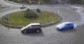 The moment a driver put their Need for Speed to the test as they drift around a busy roundabout.