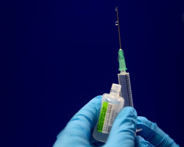 Sodium chloride is measured to be added to a phial of the Pfizer/BioNTech COVID-19 vaccine concentrate ready for administration at Guy’s Hospital in central London