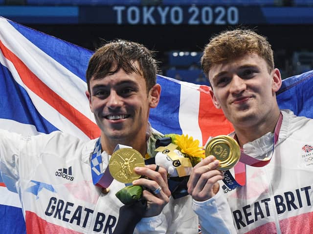 Gold medallists Britain's Thomas Daley (L) and Britain's Matty Lee poses with their medals after wining the men's synchronised 10m platform diving final event during the Tokyo 2020 Olympic Games (Photo by Oli SCARFF / AFP) (Photo by OLI SCARFF/AFP via Getty Images)