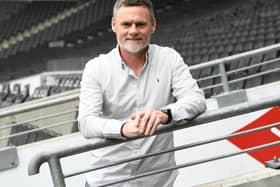 The MK Dons players will not be called back from their summer holidays early just to meet new head coach Graham Alexander