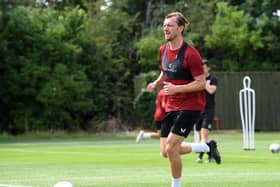 Alex Gilbey returned to pre-season training with MK Dons after re-signing for the club
