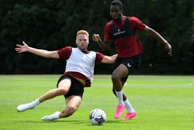 Cameron Norman slides in on Jonathan Leko in MK Dons pre-season training