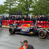 Daniel Ricciardo was behind the wheel of the Red Bull car, holding the Baton of Hope as he toured Milton Keynes. Pic: Fiona Copeland