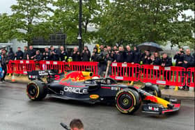 Daniel Ricciardo was behind the wheel of the Red Bull car, holding the Baton of Hope as he toured Milton Keynes. Pic: Fiona Copeland