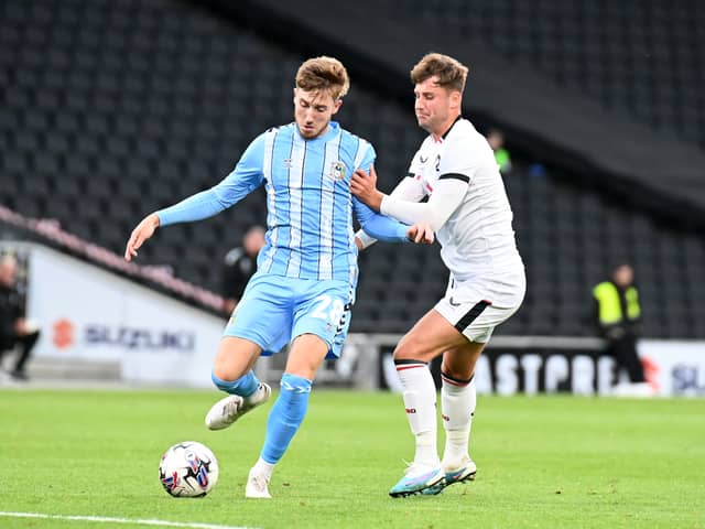 Ethan Robson battles with Coventry’s Josh Eccles during the Sky Blues’ 5-1 win over MK Dons at Stadium MK. Pic: Jane Russell