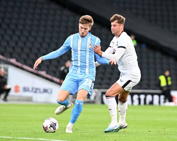 Ethan Robson battles with Coventry’s Josh Eccles during the Sky Blues’ 5-1 win over MK Dons at Stadium MK. Pic: Jane Russell