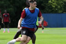 Dawson Devoy could be wearing more blue than just a bib next season after MK Dons teased a controversial blue third kit. Pic: Jane Russell
