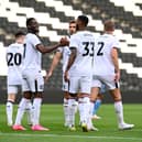 MK Dons celebrate Jonathan Leko’s penalty against Coventry City in their penultimate pre-season game. Pic: Jane Russell