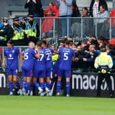 The MK Dons players celebrating with the travelling supporters in the win over Wrexham. Pic: Getty