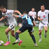 Cameron Norman battles with the ball in MK Dons’ game with Wycombe Wanderers. Pic: Jane Russell