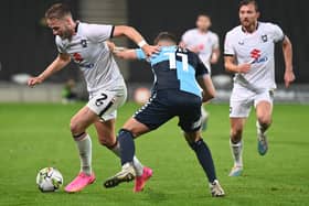 Cameron Norman battles with the ball in MK Dons’ game with Wycombe Wanderers. Pic: Jane Russell