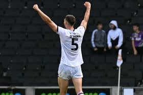 Warren O’Hora celebrates MK Dons’ win over Tranmere Rovers and the defence’s first clean sheet of the season . Pic: Jane Russell