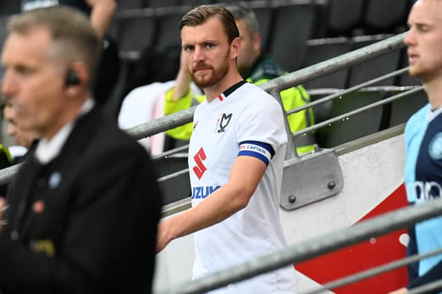 Alex Gilbey leading the side out against Wycombe Wanderers in the Carabao Cup at Stadium MK. Pic: Jane Russell