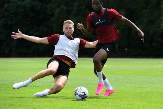 Cameron Norman throwing himself into a tackle with Jonathan Leko in training. Pic: Jane Russell