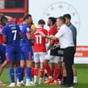 Alex Gilbey in discussion with MK Dons head coach Graham Alexander. Pic: Liam Ford/AHPIX LTD