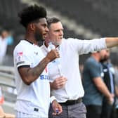 Graham Alexander gives some instructions to Ellis Harrison ahead of his MK Dons debut against Notts County. Pic: Jane Russell