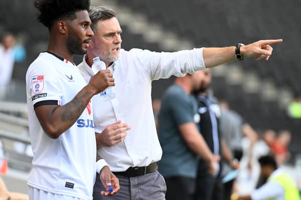 Graham Alexander gives some instructions to Ellis Harrison ahead of his MK Dons debut against Notts County. Pic: Jane Russell