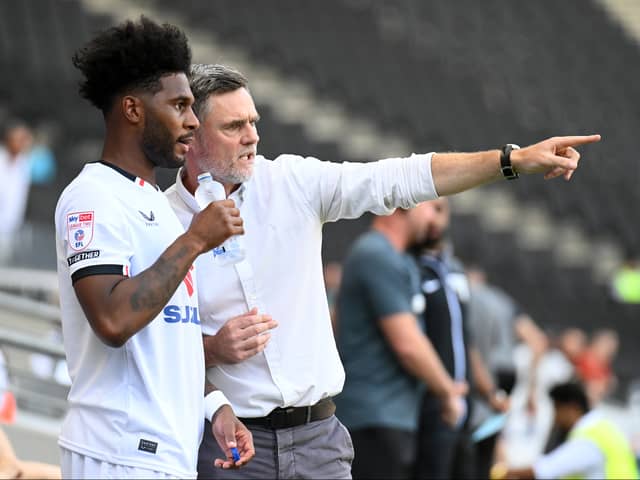 Graham Alexander gives some instructions to Ellis Harrison ahead of his MK Dons debut against Notts County. Pic: Jane Russell