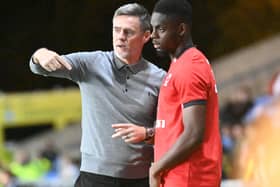 Graham Alexander gives instructions to Jonathan Leko on the sidelines at Oxford