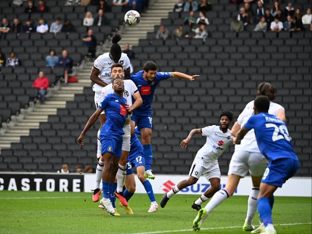Anthony Stewart and Warren O’Hora battle in the air for the ball against Harrogate Town. Pic: Jane Russell