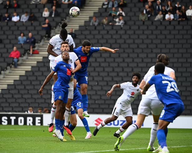 Anthony Stewart and Warren O’Hora battle in the air for the ball against Harrogate Town. Pic: Jane Russell