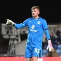 Goalkeeper Michael Kelly will remain a part of the MK Dons fold until at least January after signing a new short-term deal