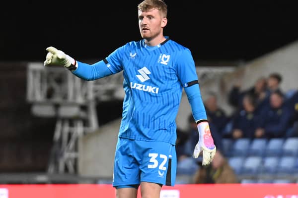 Goalkeeper Michael Kelly will remain a part of the MK Dons fold until at least January after signing a new short-term deal