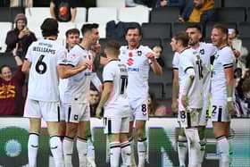 MK Dons celebrate Warren O’Hora’s excellent second goal against Swindon Town