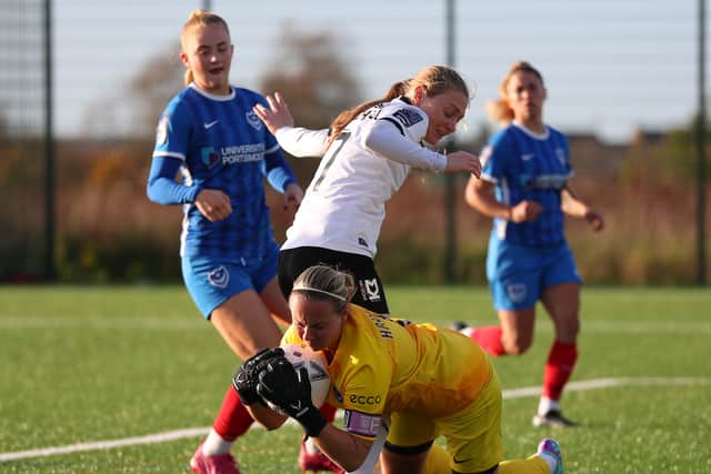 Dons’ Laura Mitchell is beaten to the ball by Portsmouth keeper Hannah Haughton. Pic: CTF Photography