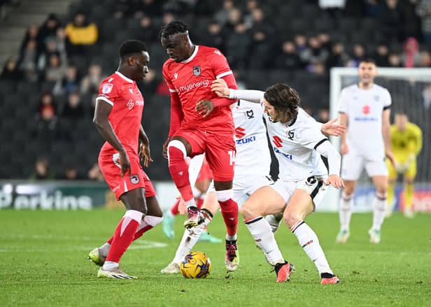 Grimsby Town battle in the midfielder against MK Dons