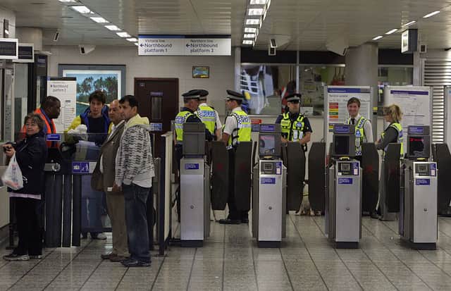 Police officers prepare for members of the jury sitting on the inquest into the shooting of Jean Charles de Menezes to visit Stockwell Underground Station on September 23 2008 in London.
