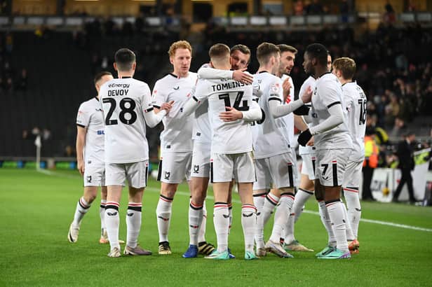MK Dons celebrate the opening goal against Crawley