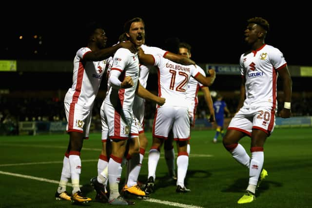 Gilbey celebrates in front of the AFC Wimbledon fans during the 2-0 win in 2017 under Robbie Neilson