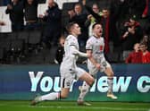 Joe Tomlinson and Jack Payne celebrate the late winner against Accrington