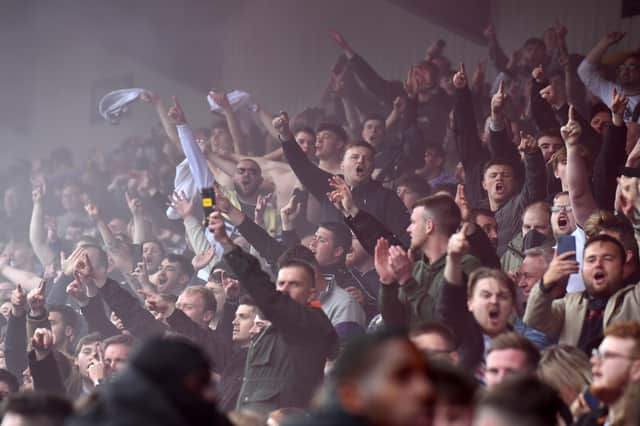 MK Dons supporters celebrate Troy Parrott's remarkable volley to equalise against AFC Wimbledon in April 2022