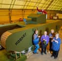 (L to R) Lynn Hart, Hazel Barker, Carol Dunkley, Sandra Searle and Stuart Martin beside the knitted tank.