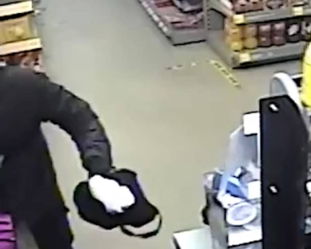 Suspect threatens shop worker with machete.
