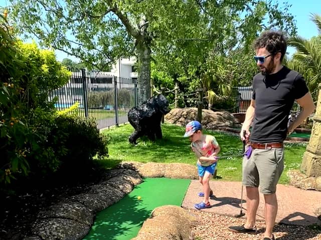 George accidentally hits his dad James between the legs at crazy golf.