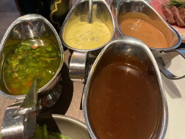 Clockwise from left: chimichurri, béarnaise, peppercorn and port sauces.