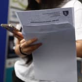 A student receives A-level results. 