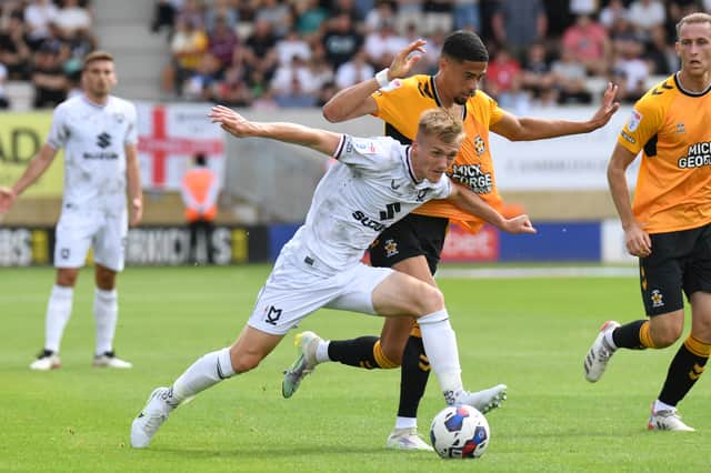 Matt Smith battles for the ball against Cambridge United on opening day in 2022